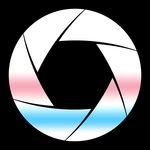 A white camera aperture symbol on a transparent background with gradients of pink and blue to evoke the trans flag.