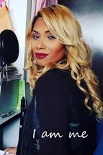 Jazmine Smith looks over her shoulder with a slight smile. Jazmine is a Cree person with light skin, blond hair in loose curls, and wearing makeup. The words " I am me" are super-impossed in the bottom right in a white cursive scrawl.