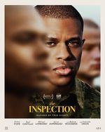 In the foreground, a face is out of focus. Peeking around behind them is Ellis, a Black person with a buzzcut and wearing a military green camo top.